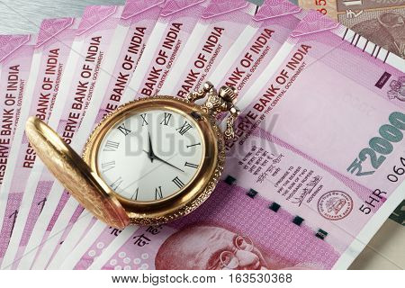 New Indian Rupees Currency with antique time watch