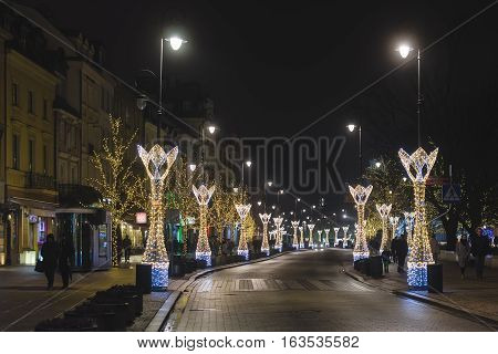 Warsaw, Poland - December 25th, 2016. Barbican fortress wall and Christmas decorations at the Warsaw Old town by Xmas night.