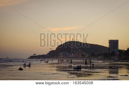 People Playing On The Beach At Sunset