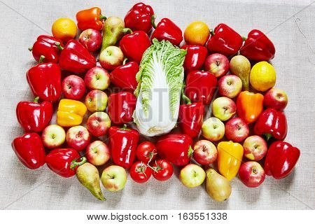 Cabbage tasty ripe red yellow and orange paprika tomato apple pearcitrus lies on a gray canvas