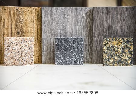 Three different color wood samples with complimenting kitchen or bath counter top block samples.