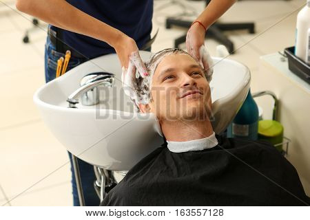 Female Hands Washing Hair To Handsome Smiling Man