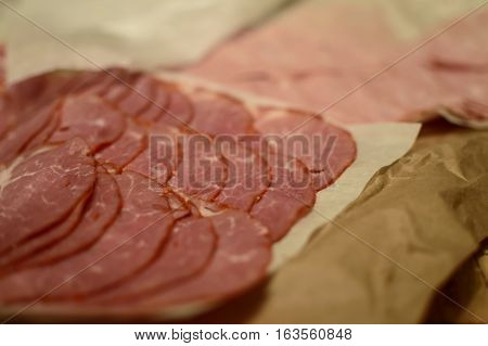 Close-up of sliced deli Italian Food sandwich meats or cold cuts for buffet antipasto entertaining with selective focus for copy space