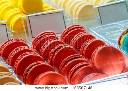 Tasty french macarons on a wooden table with vintage color tone, Macarons is a French sweet meringue based Sweet colorful macarons