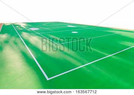 Empty rattan ball court with sunlight in summer. green court floor with white line.