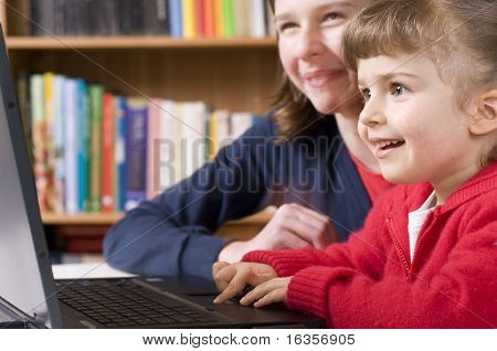Sisters working on laptop