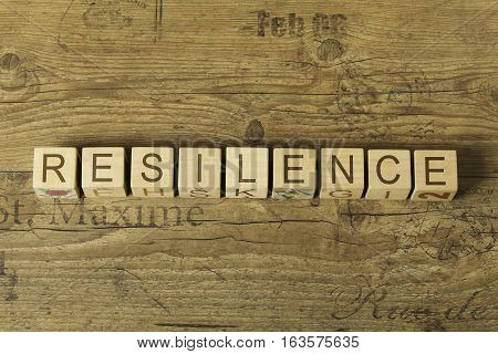 resilence word on cubes on wooden background