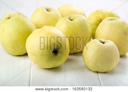 Ripe Antonovka apples on white wooden table