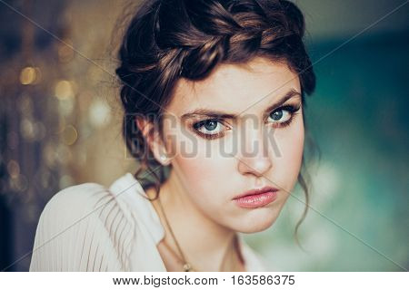 Beautiful young woman. Professional make-up and hairstyle. Perfect skin. Fashion photo.