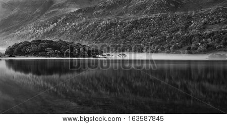Beautiful Autumn Fall Black And White Landscape Image Of Crummock Water At Sunrise In Lake District