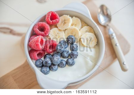 Healthy Yogurt with fresh fruit on a table