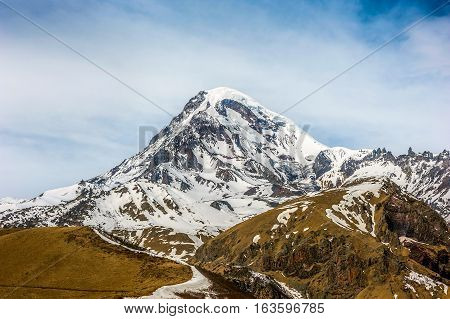 Georgia view of Mount Kazbek from the temple Sameba Gergeti Gergeti village .
