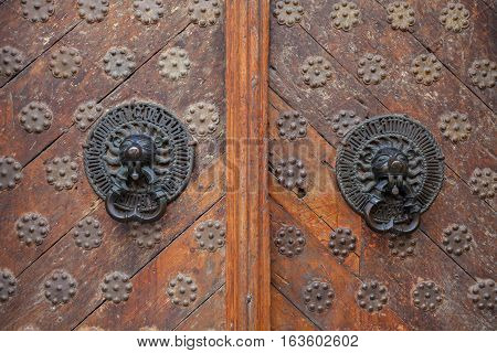 Twin antique handles old style on wooden doors stock photo