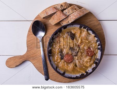 Slovak national christmas cabbage soup kapustnica with mushrooms on white background.