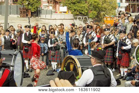 MOSCOW, RUSSIA - September 4, 2016: Dancing girls during show of Celtic pipes and drums band surrounded by townspeople in the Park on the Crimean embankment. Festival of military orchestras 