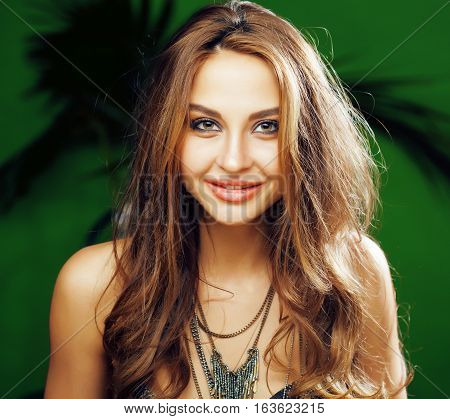 young cute blonde woman on green palm background smiling happy, lifestyle peole concept close up