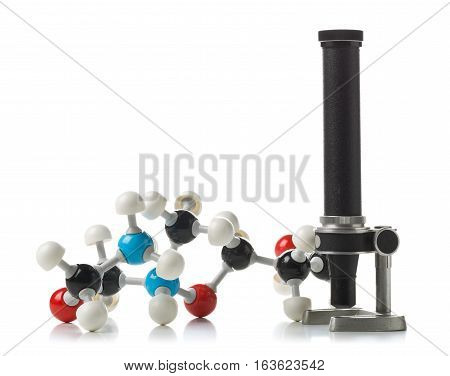 Chemical molecule model with old microscope over white background. Science or research history concept
