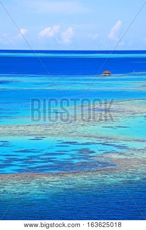 Fishing shack off Raiatea island in Tahiti. Coral bench inside the reef.