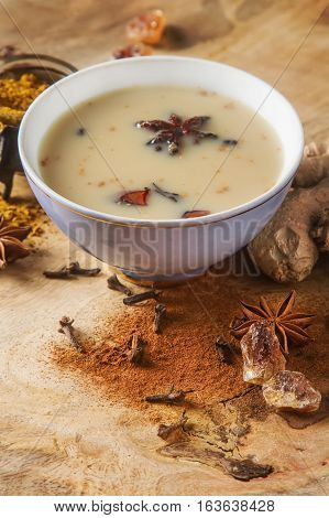 Traditional Indian Masala Tea In Ceramic Cup With Spices To Milk