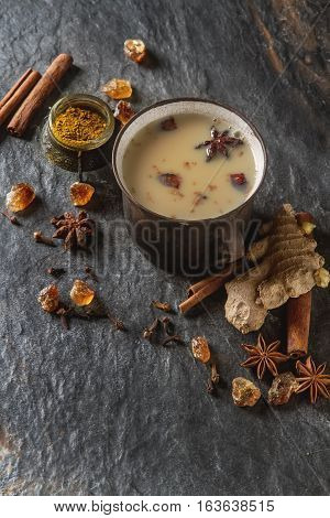 Traditional Indian Masala Tea In Ceramic Cup With Spices To Milk