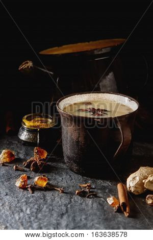 Traditional Indian Masala Tea In Ceramic Cup With Spices To Milk