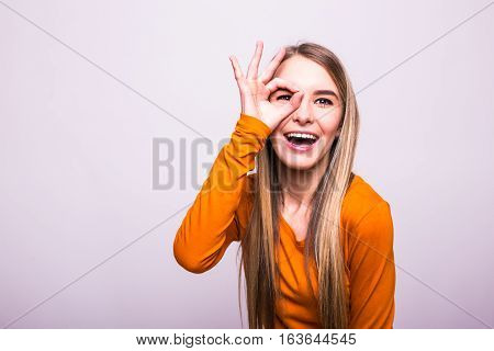 Happy Blonde Girl With Okay Gesture On White