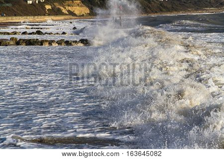 Waves on sandy beach. Mudeford Christchurch England United Kingdom.