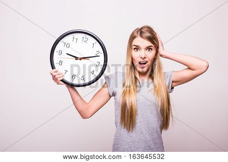 Shocked girl because be late at clock time