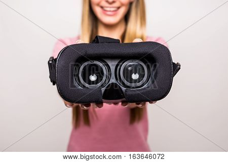 Girl give virtual reality goggles white back