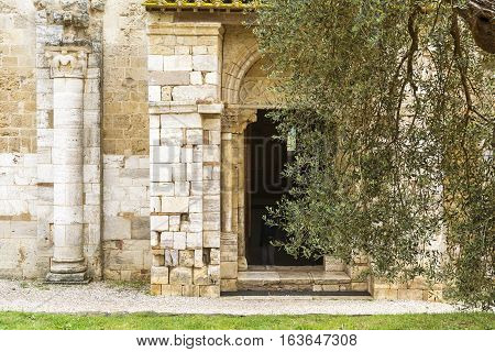 PIENZA,ITALY-APRIL 24,2016:Main entrance of the saint Antimo Abbey in Tuscany-Italy during a cloudy day.