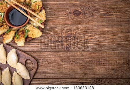 Homemade asian сhicken potstickers with soy sauce.