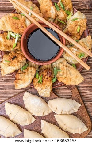Homemade asian сhicken potstickers with soy sauce.