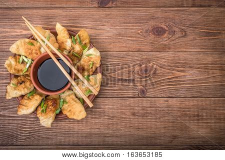 Homemade asian сhicken potstickers with soy sauce.