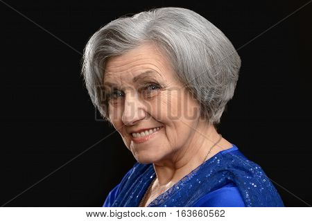 beautiful mature woman, posing on black background