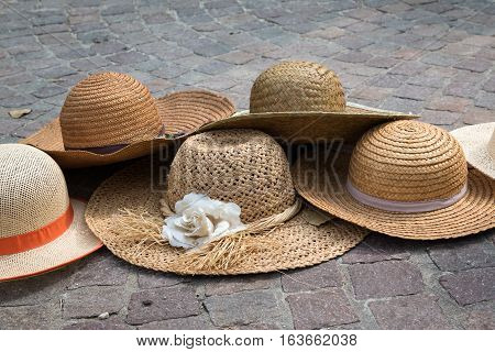 Group of straw Hats on Classic Sampietrini Ground in Italy