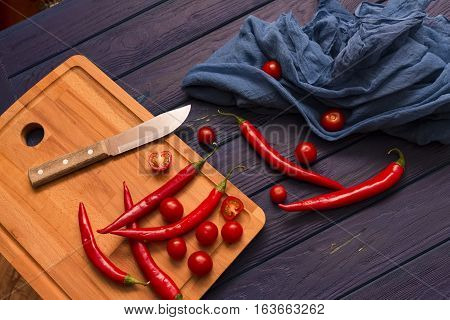red chili pepper on the wood blue table with the shawl