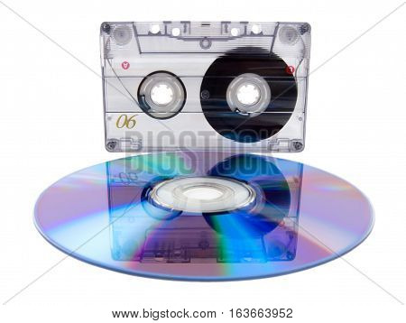 Analog audio tape cassette and digital compact disc isolated on a white background