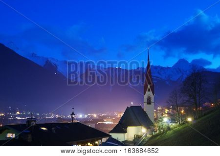 Illuminated church Chapel in a mountainous region the alps at night