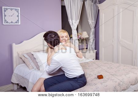 Handsome man doing a marriage proposal while offering his wife an engagement ring. Boyfriend make a marriage proposal to his girlfriend in valentine days.