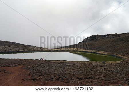 Lake Waiau surrounded by misty clouds, near the summit of Mauna Kea, Big Island, Hawaii