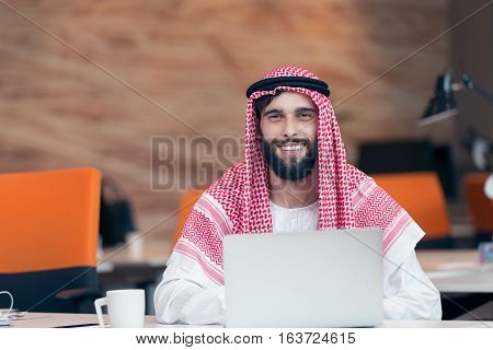 Arabian businessman working in modern startup office.