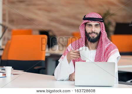 Arabian businessman working in modern startup office.
