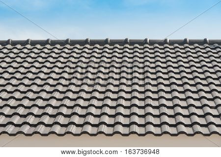 Rows of roof tiles on the top of house with sky background.