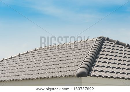 Rows of roof tiles on the top of house with sky background.
