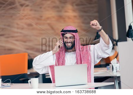 Arabian businessman working in modern startup office.