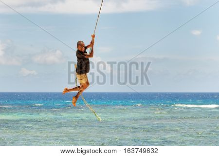 Lavena, Fiji - November 27: Unidentified Boy Swings On A Rope Swing On November 27, 2013 In Lavena V