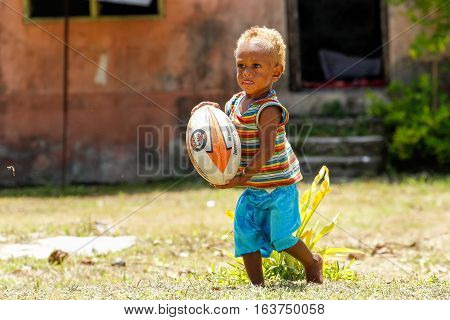 Lavena, Fiji - November 27: Unidentified Boy Plays With Rugby Ball On November 27, 2013 In Lavena Vi