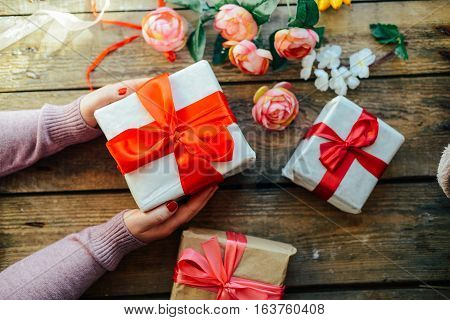 Valentine's Day Concept. Gift With Red Bow  On The Wooden Backg
