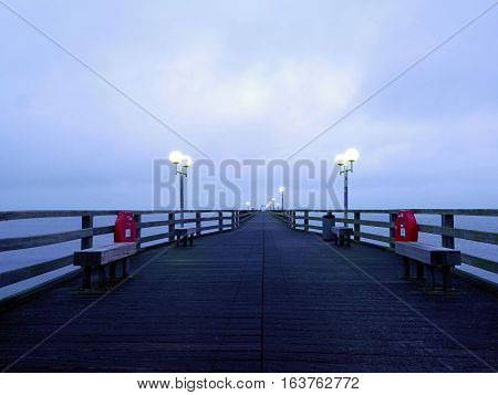 Long Touristic Mole Within Autumn Misty Morning. Wet And Slippery Wooden Floor,