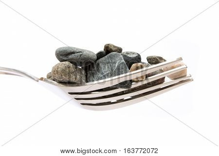 Concept about hard digestion. Fork with stones